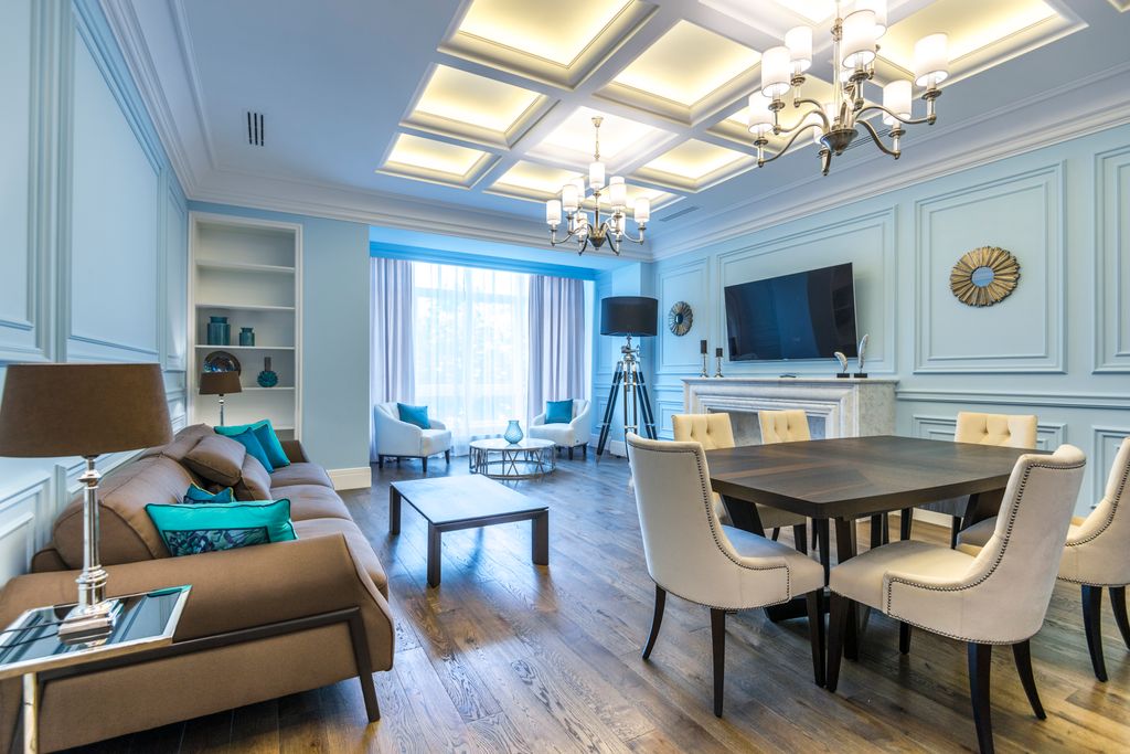 Sophisticated living room featuring modern furniture, chandeliers, and soothing decor.